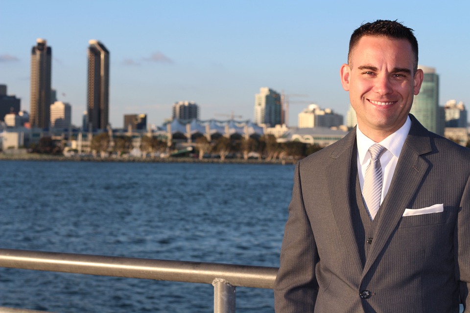 person, water, buildings in background