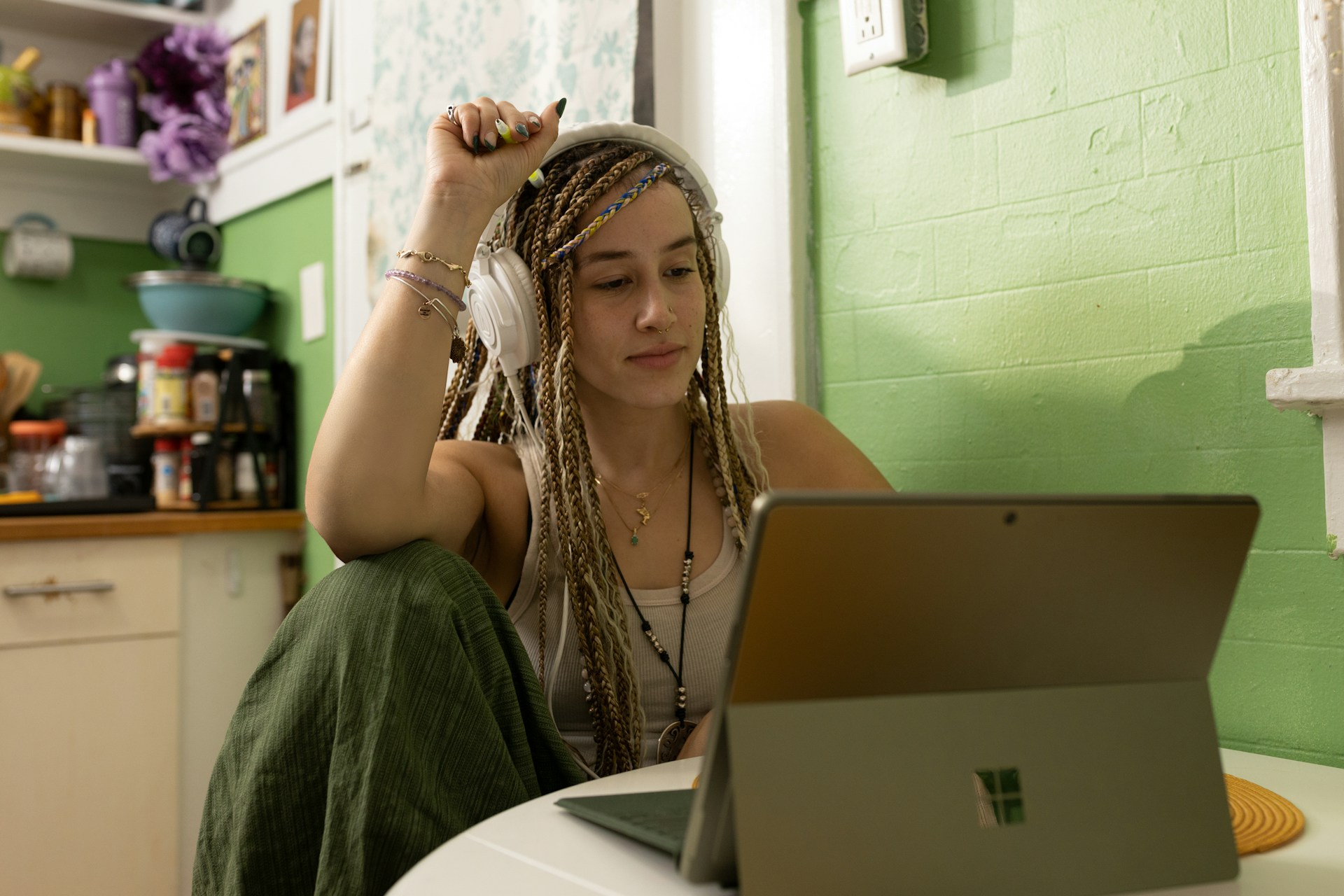 Person with headphones in front of a computer. Image by Unsplash