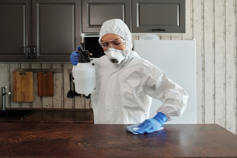 Person disinfecting a table