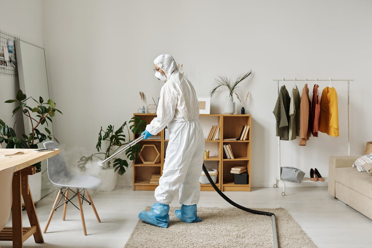 Person disinfecting a chair. Image by Pexels