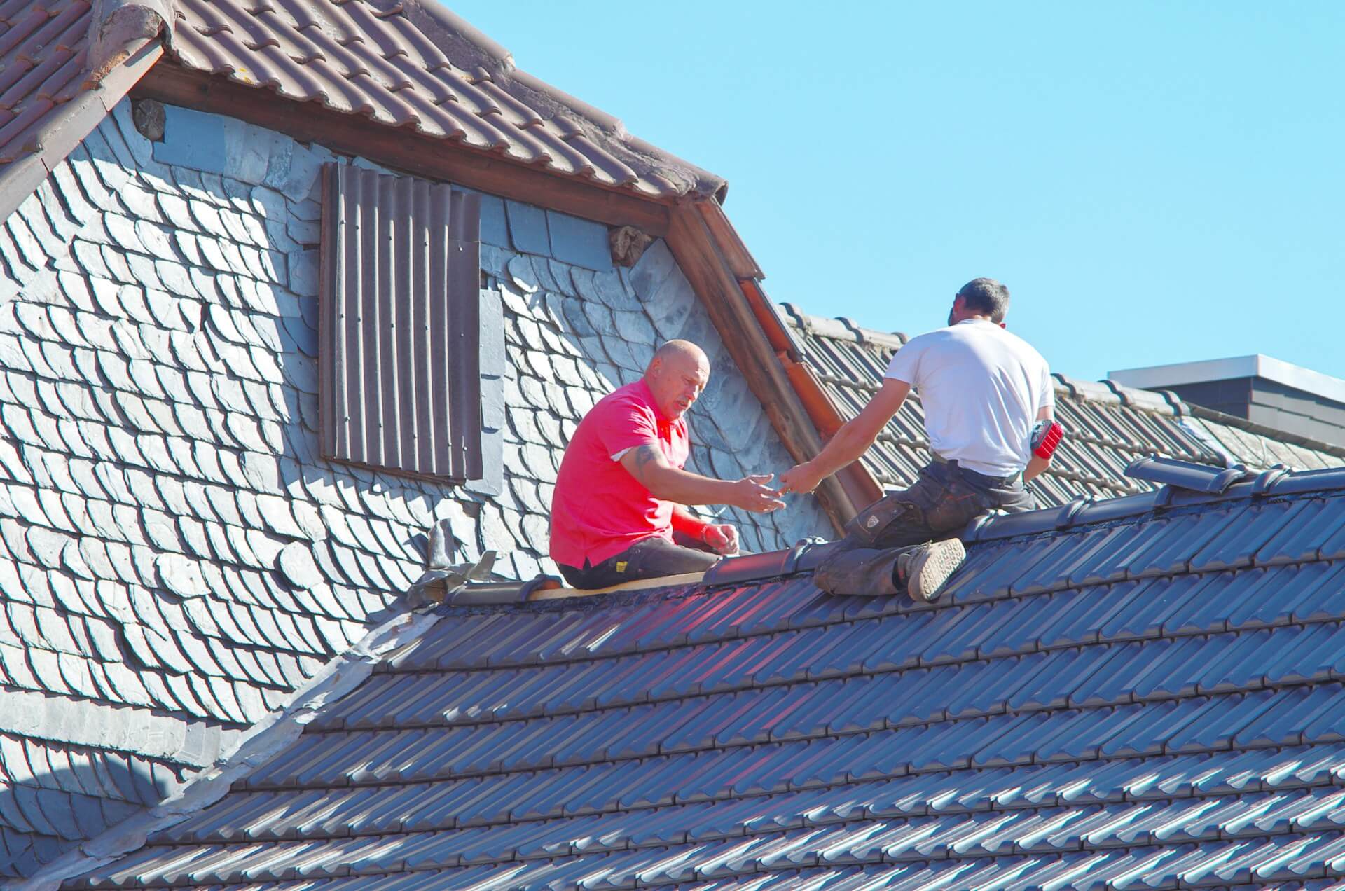 2 people working on top of a rooftop. Image by Unsplash