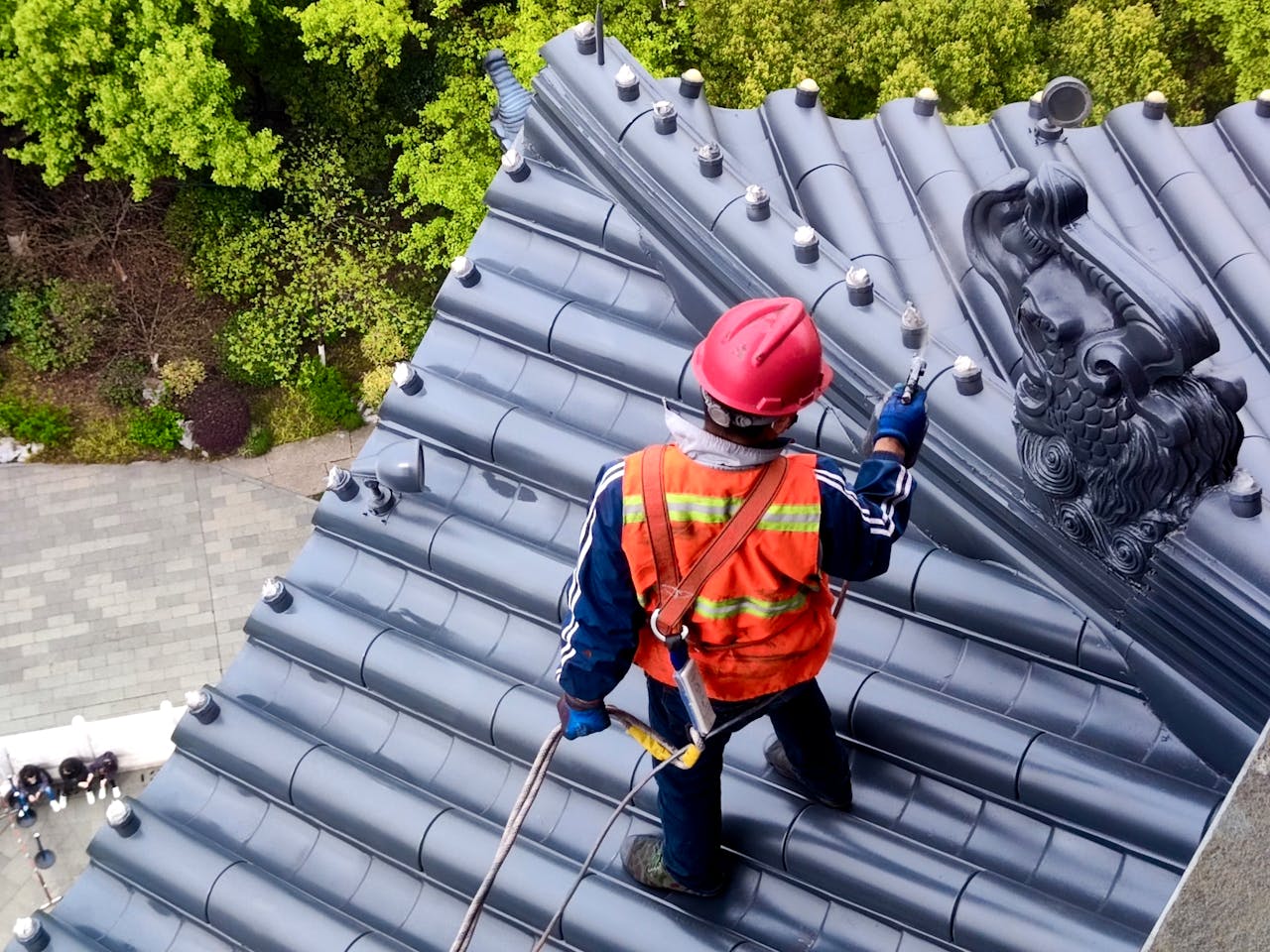Person working on a rooftop. Image by Pexels