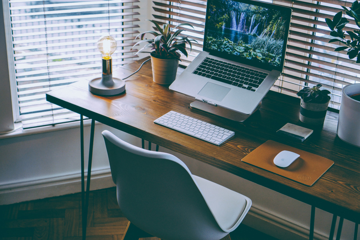 Office deskts with computers, 1 person working