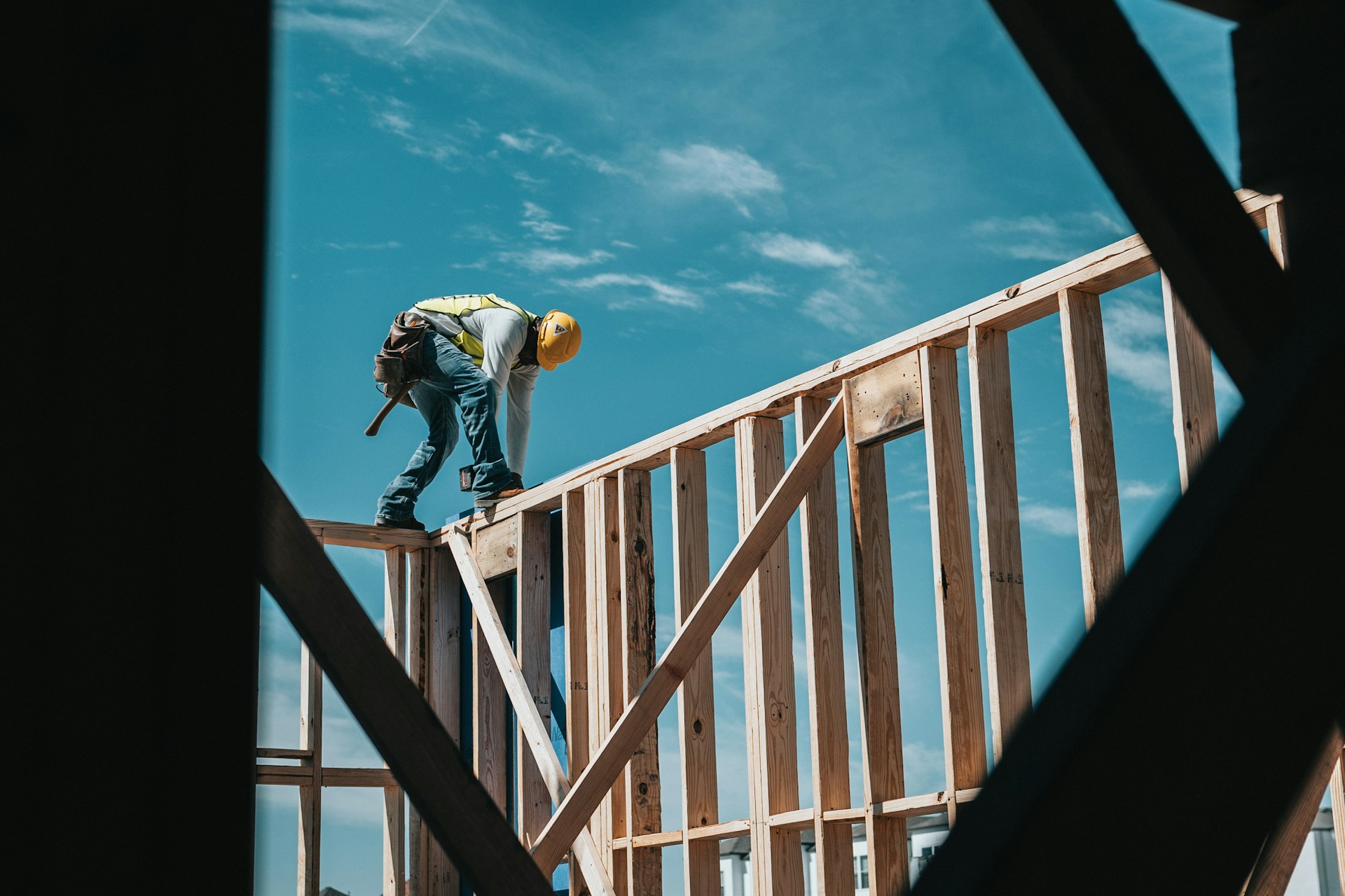 Person with a yellow hard hat working at a construction site.