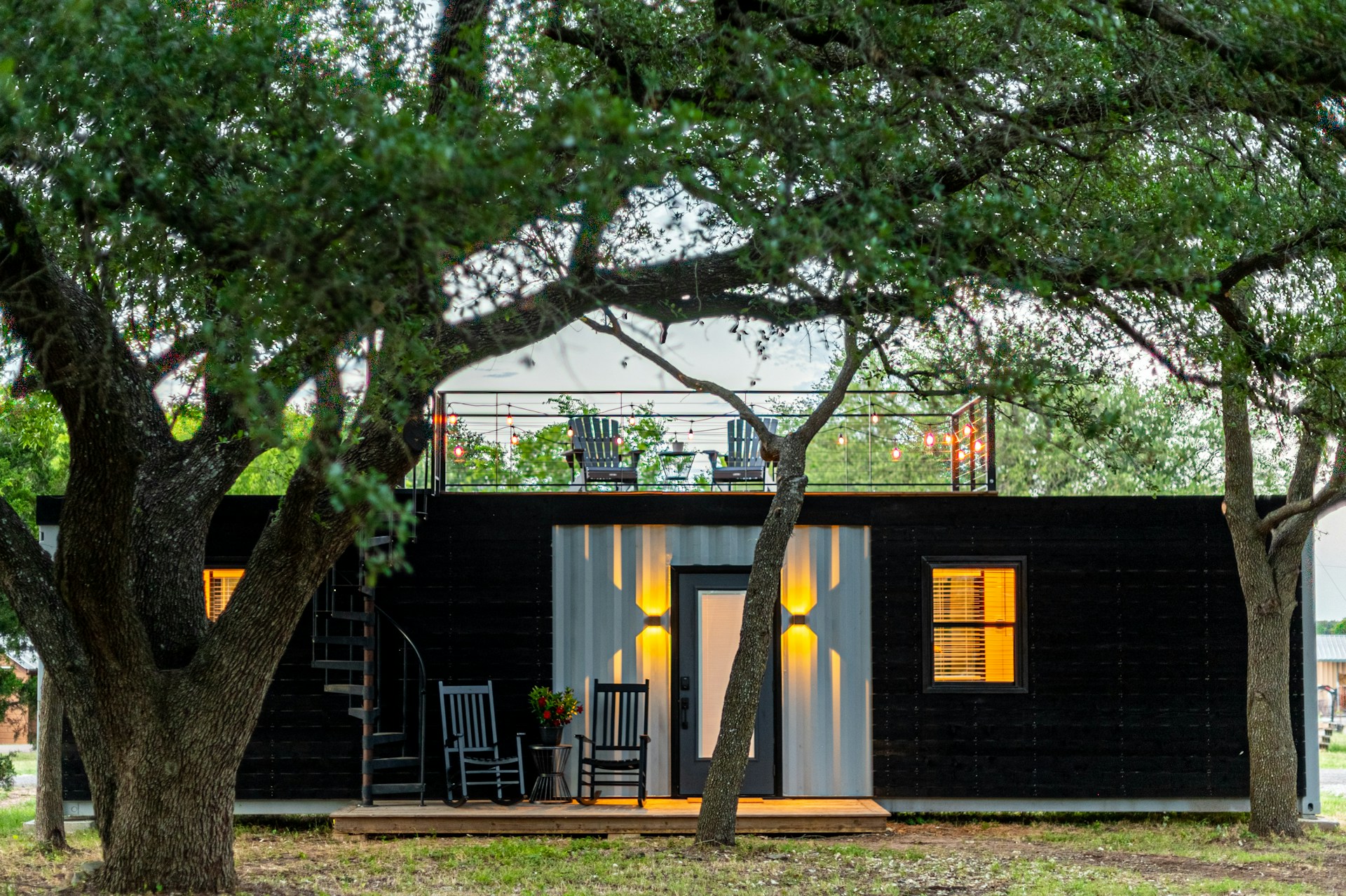 Wooden house near trees, deck on top of the roof. Image by Unsplash