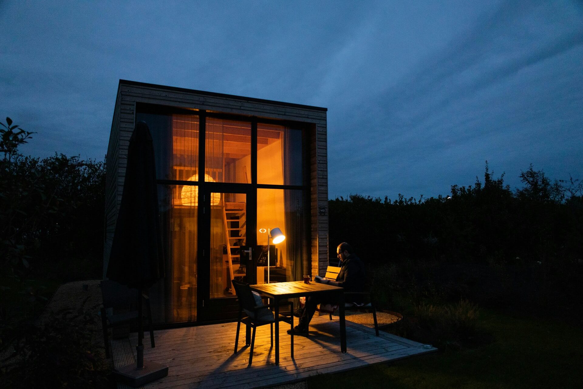 Outside of a tiny house at night. Image by Unsplash