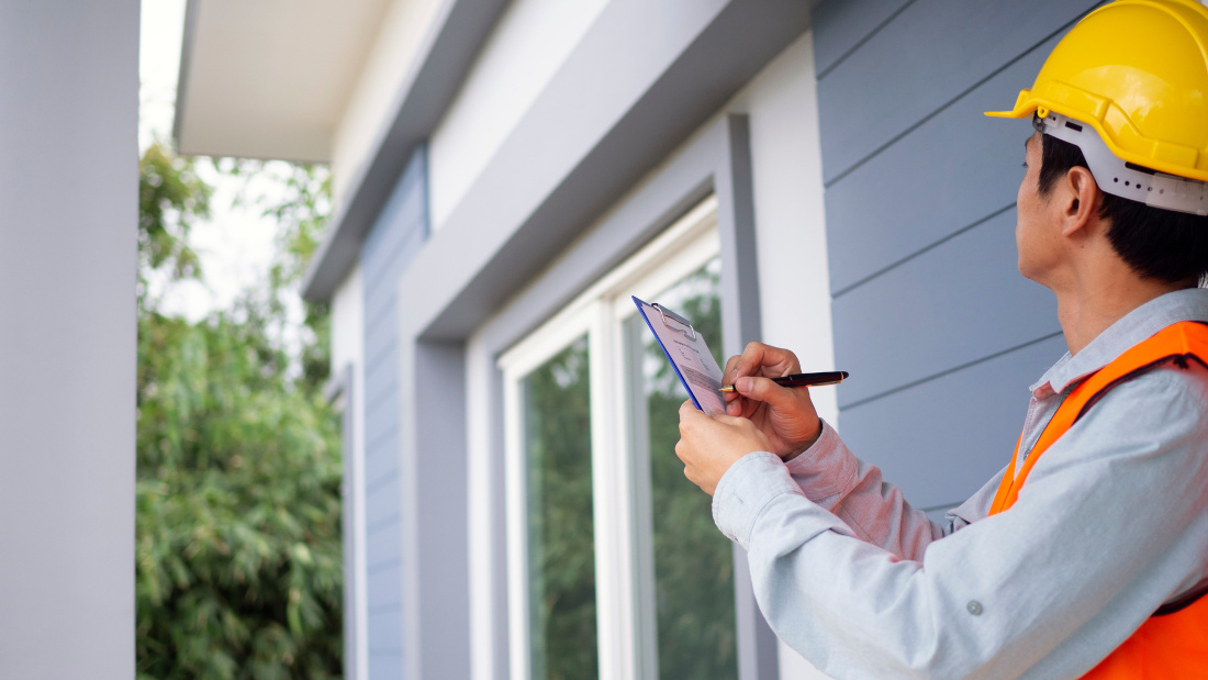 person with taking notes during a home inspection