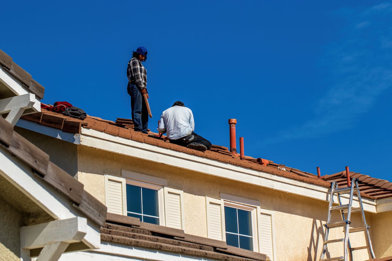 2 people repairing a roof