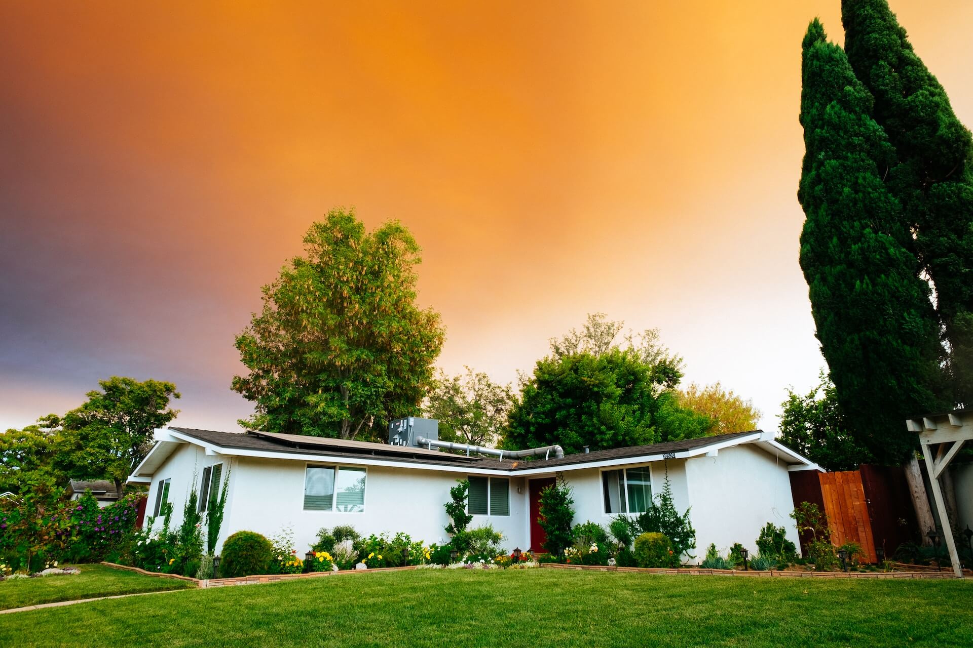 white ranch style house, orange sky