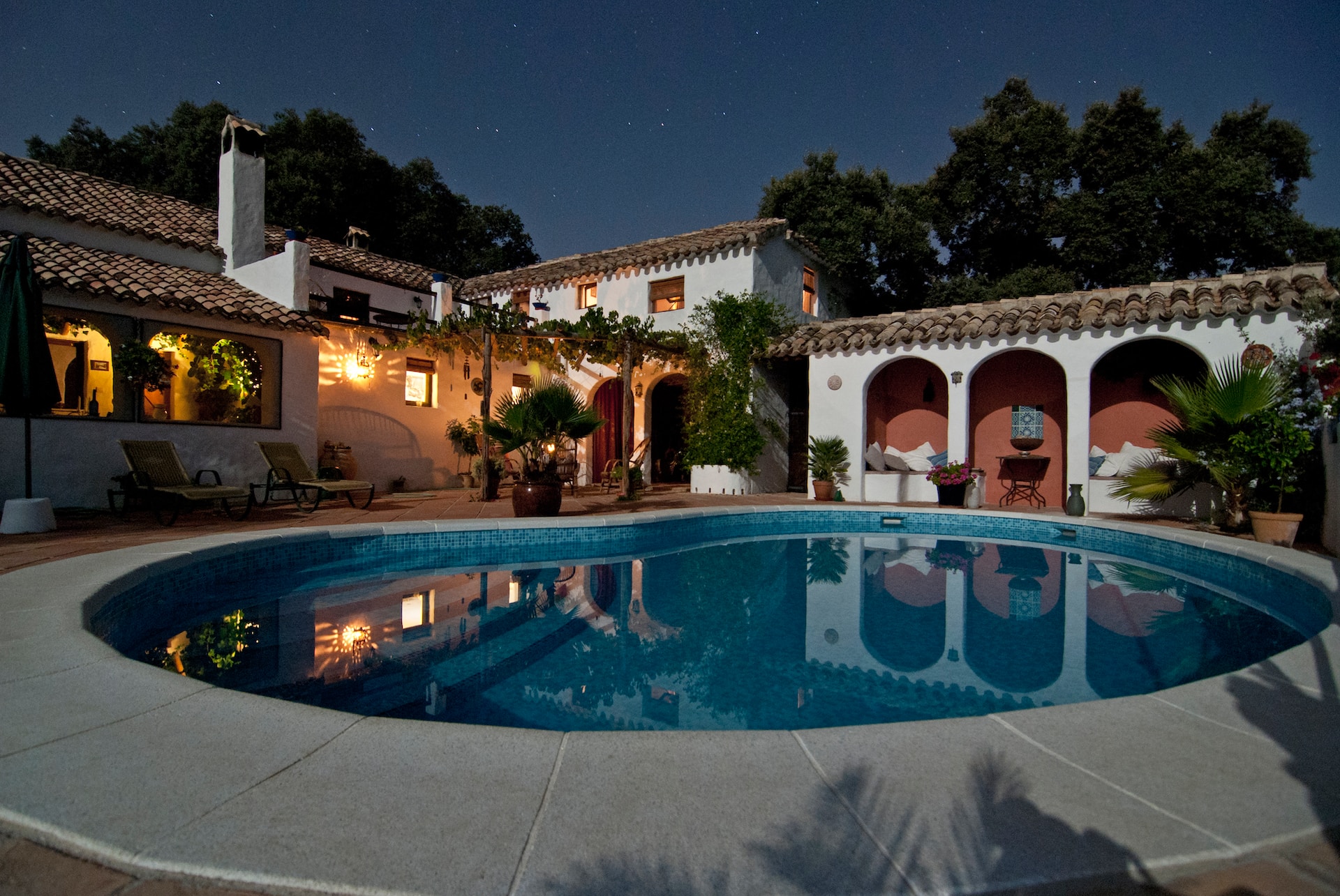 white house, outdoor pool, night time