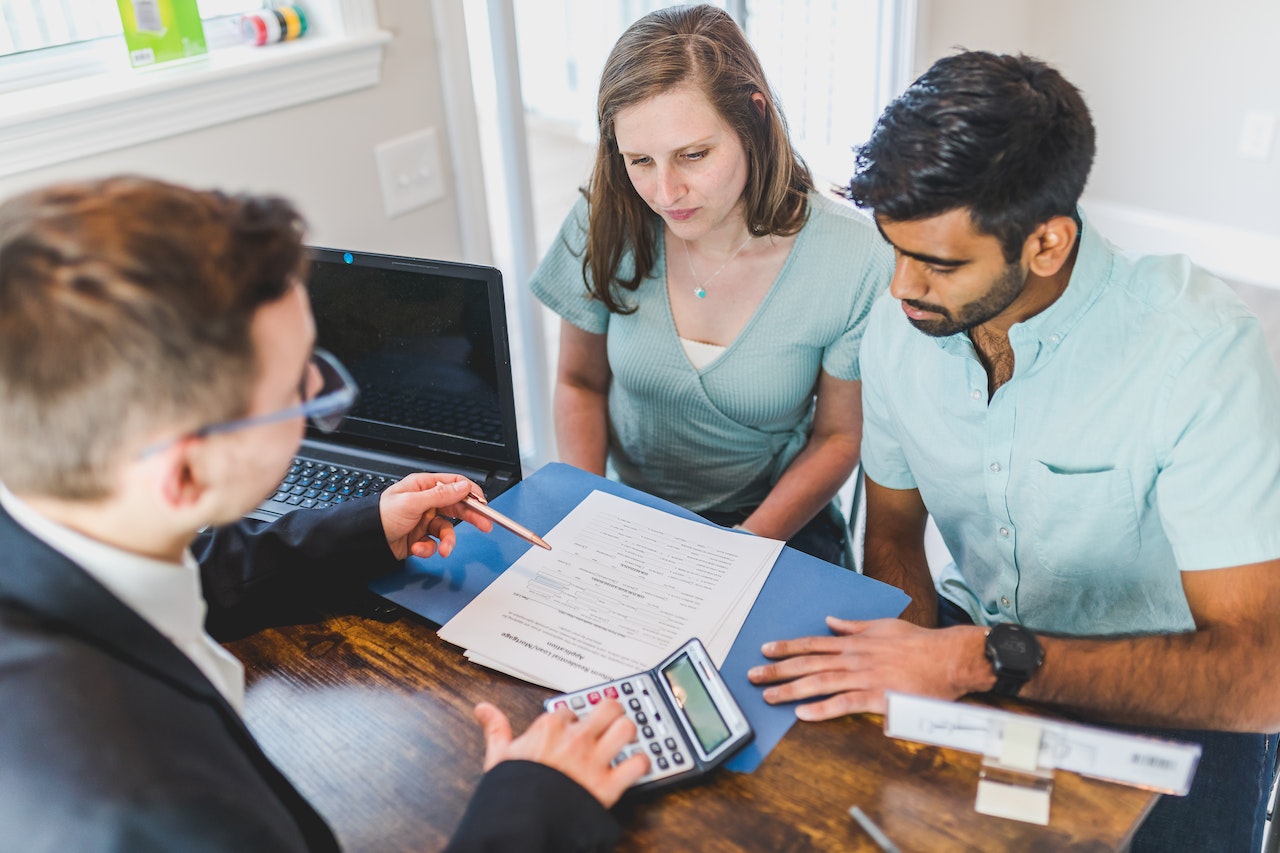 Person explanining paperwork to a couple