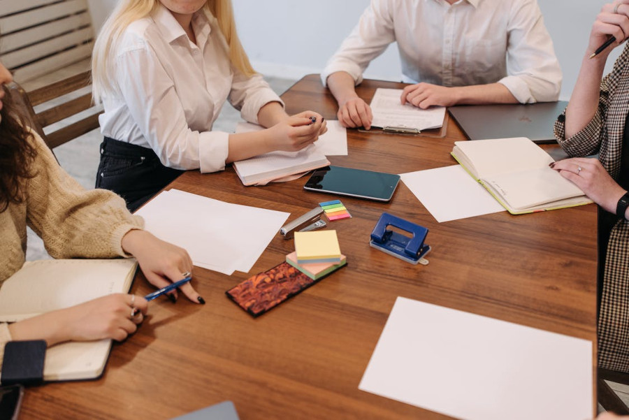 Four people sitting around a table with paperwork