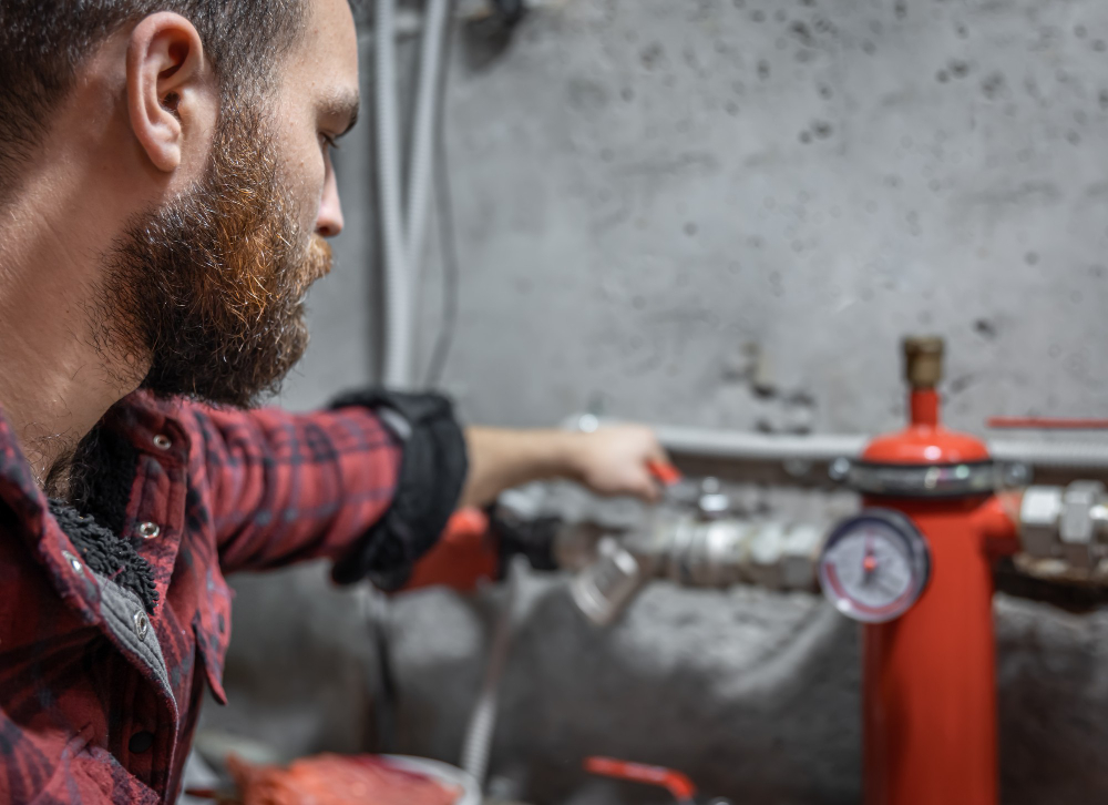 person looking at the faucet, pipes, valve, pressure meter