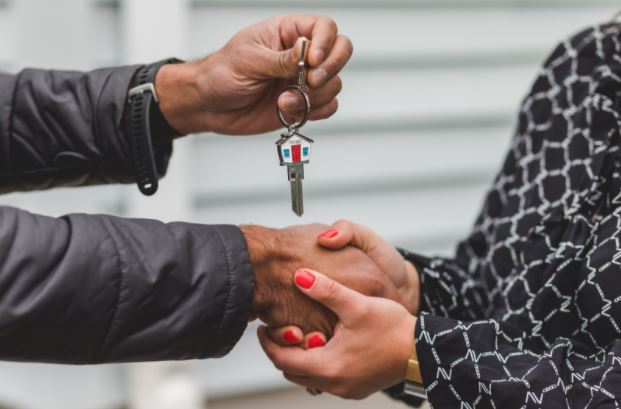 person handing over keys