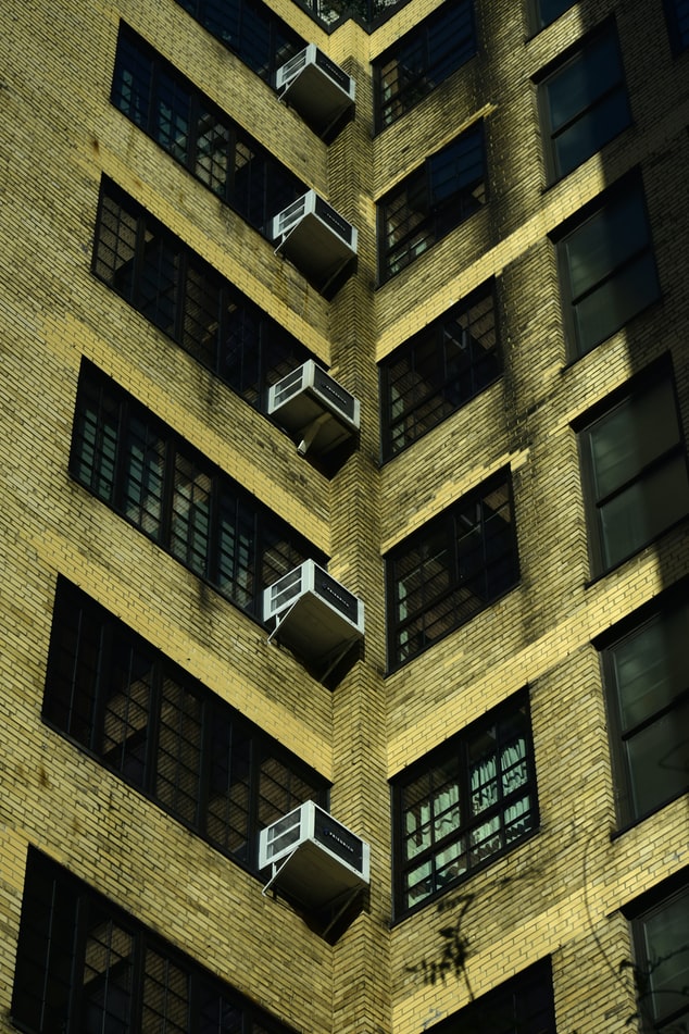 Tall building with lost of air conditioners in the windows