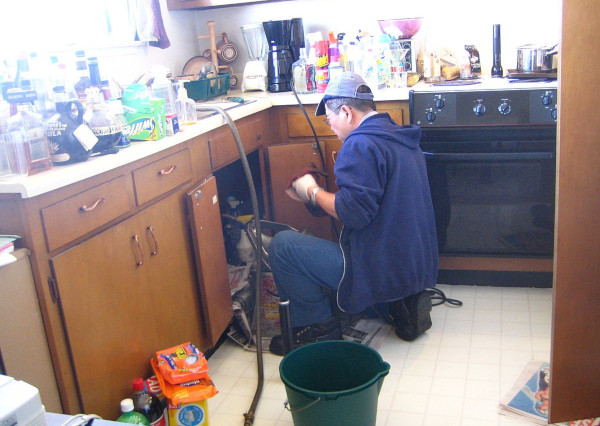 Plumber in kitchen